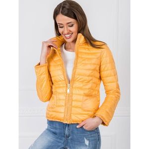 Yellow quilted jacket vyobraziť